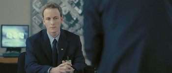 Movie still from “88 Minutes” (2007), directed by Jon Avnet – A man in a suit and tie holding a cell phone; Close Up shot, Over the shoulder angle