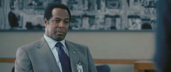 Movie still from “88 Minutes” (2007), directed by Jon Avnet – A man in a suit and tie in front of a wall; Close Up shot, Low angle