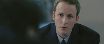 Movie still from “88 Minutes” (2007), directed by Jon Avnet – A man in a suit and tie looking at the camera; Close Up shot, High angle