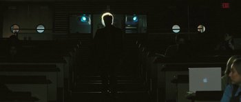 Movie still from “88 Minutes” (2007), directed by Jon Avnet – A man standing in front of a row of chairs; Wide shot, Low angle