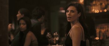 Movie still from “88 Minutes” (2007), directed by Jon Avnet – A beautiful young lady standing in front of a table; Close Up shot, Over the shoulder angle