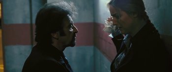 Movie still from “88 Minutes” (2007), directed by Jon Avnet – A man and a woman standing next to each other; Close Up shot, Low angle