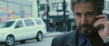 Movie still from “88 Minutes” (2007), directed by Jon Avnet – A person wearing a suit on a city street; Close Up shot, Over the shoulder angle