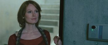 Movie still from “88 Minutes” (2007), directed by Jon Avnet – A woman standing next to a wall holding a pen; Close Up shot, Over the shoulder angle