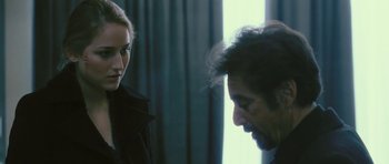 Movie still from “88 Minutes” (2007), directed by Jon Avnet – A man and a woman standing next to each other in front of a window; Close Up shot, Over the shoulder angle