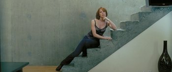 Movie still from “88 Minutes” (2007), directed by Jon Avnet – A woman sitting on top of a set of stairs; Medium shot, Low angle