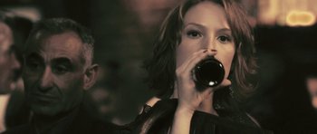 Movie still from “88 Minutes” (2007), directed by Jon Avnet – A woman is drinking a beverage from a cup; Close Up shot, Over the shoulder angle