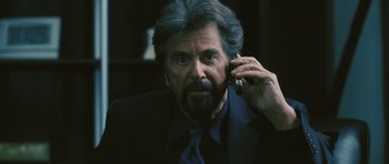 Movie still from “88 Minutes” (2007), directed by Jon Avnet – An older man in a suit and tie talking on a cell phone; Close Up shot, Over the shoulder angle