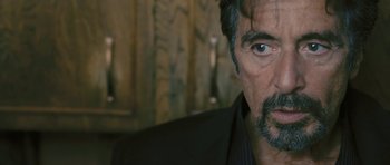 Movie still from “88 Minutes” (2007), directed by Jon Avnet – Close up of a man's face in a black suit; Close Up shot, Over the shoulder angle