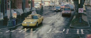 Movie still from “88 Minutes” (2007), directed by Jon Avnet – A yellow taxi driving down a wet city street; Extreme Wide shot, High angle