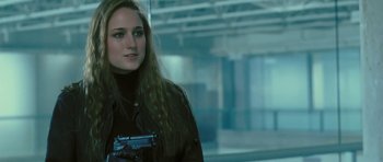 Movie still from “88 Minutes” (2007), directed by Jon Avnet – A woman holding a gun while standing in front of a building; Close Up shot, Over the shoulder angle