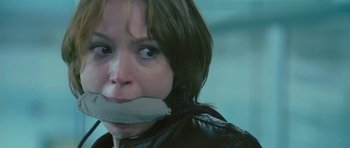 Movie still from “88 Minutes” (2007), directed by Jon Avnet – A woman with duct tape around her mouth; Close Up shot, Low angle