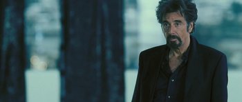 Movie still from “88 Minutes” (2007), directed by Jon Avnet – A person wearing a suit and glasses; Medium shot, Over the shoulder angle