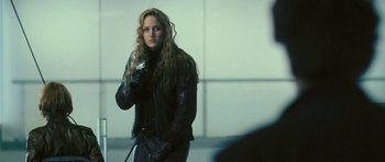 Movie still from “88 Minutes” (2007), directed by Jon Avnet – A woman in a black jacket and black gloves; Medium shot, Over the shoulder angle