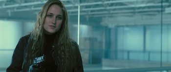 Movie still from “88 Minutes” (2007), directed by Jon Avnet – A woman with long hair standing next to a building; Close Up shot, Low angle