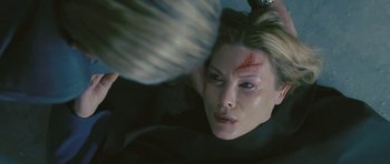 Movie still from “88 Minutes” (2007), directed by Jon Avnet – A woman with makeup on her face is looking into the camera; Close Up shot, Overhead angle