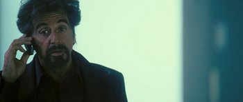 Movie still from “88 Minutes” (2007), directed by Jon Avnet – A man in a black jacket is standing in front of a white wall; Close Up shot, Low angle