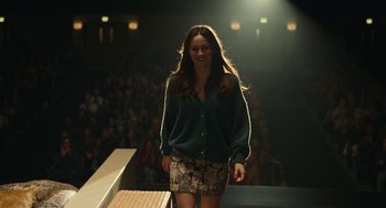 Movie still from “Euphoria” (2019), created by Sam Levinson – A woman walking down a runway in front of an audience; Medium shot, Over the shoulder angle