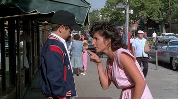 Movie still from “A Bronx Tale” (1993), directed by Robert De Niro – A man and a woman on the sidewalk; Medium shot, Over the shoulder angle