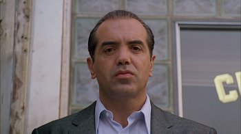 Movie still from “A Bronx Tale” (1993), directed by Robert De Niro – A person wearing a suit and tie; Close Up shot, Low angle