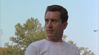 Movie still from “A Bronx Tale” (1993), directed by Robert De Niro – A person wearing a white t - shirt; Close Up shot, Low angle