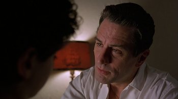 Movie still from “A Bronx Tale” (1993), directed by Robert De Niro – A person talking to another person; Close Up shot, Over the shoulder angle
