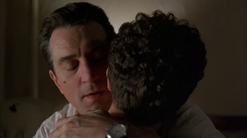 Movie still from “A Bronx Tale” (1993), directed by Robert De Niro – A person hugging another person; Close Up shot, Low angle