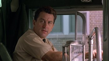 Movie still from “A Bronx Tale” (1993), directed by Robert De Niro – A man standing in front of a window; Close Up shot, Low angle