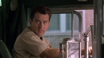 Movie still from “A Bronx Tale” (1993), directed by Robert De Niro – A person standing next to a window; Close Up shot, Low angle