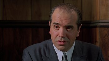 Movie still from “A Bronx Tale” (1993), directed by Robert De Niro – A person wearing a suit and tie; Close Up shot, Low angle