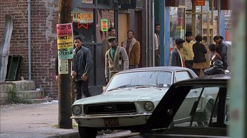 Movie still from “A Bronx Tale” (1993), directed by Robert De Niro – A group of men standing next to each other on a street; Wide shot, High angle