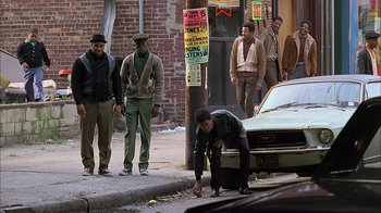 Movie still from “A Bronx Tale” (1993), directed by Robert De Niro – A group of men standing on the side of the street; Wide shot, High angle