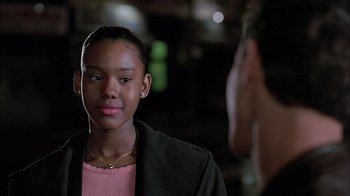Movie still from “A Bronx Tale” (1993), directed by Robert De Niro – A young woman is looking into the camera; Close Up shot, Over the shoulder angle