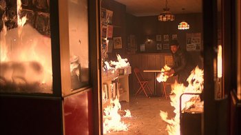 Movie still from “A Bronx Tale” (1993), directed by Robert De Niro – A man sitting in front of a fire in a room; Wide shot, High angle