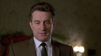 Movie still from “A Bronx Tale” (1993), directed by Robert De Niro – A person wearing a suit and tie; Close Up shot, Low angle