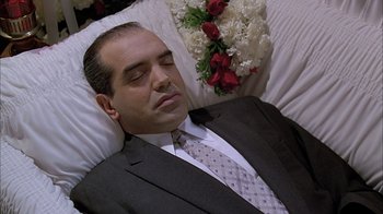 Movie still from “A Bronx Tale” (1993), directed by Robert De Niro – A man in a suit and tie sleeping in a bed; Medium shot, High angle