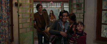 Movie still from “A Death in the Gunj” (2016), directed by Konkona Sen Sharma – A group of people standing in front of a building; Medium shot, Over the shoulder angle