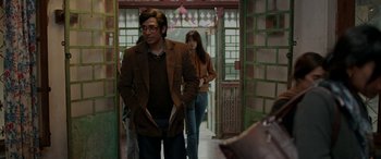 Movie still from “A Death in the Gunj” (2016), directed by Konkona Sen Sharma – A man and a woman walking down a hall way; Medium shot, Over the shoulder angle