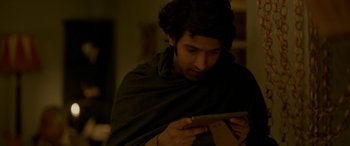 Movie still from “A Death in the Gunj” (2016), directed by Konkona Sen Sharma – A man is looking at his cell phone; Close Up shot, Over the shoulder angle