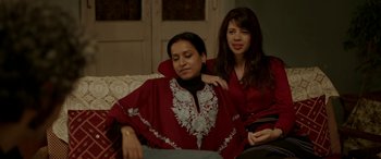 Movie still from “A Death in the Gunj” (2016), directed by Konkona Sen Sharma – Two women sitting on a couch in a room; Medium shot, High angle