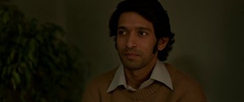 Movie still from “A Death in the Gunj” (2016), directed by Konkona Sen Sharma – A person wearing a shirt and a sweater; Close Up shot, High angle