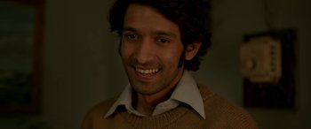 Movie still from “A Death in the Gunj” (2016), directed by Konkona Sen Sharma – A person wearing a shirt and a sweater; Close Up shot, High angle