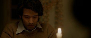 Movie still from “A Death in the Gunj” (2016), directed by Konkona Sen Sharma – A man sitting in front of a lit candle; Close Up shot, High angle