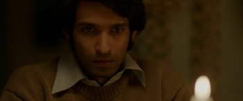 Movie still from “A Death in the Gunj” (2016), directed by Konkona Sen Sharma – A person wearing a shirt and a sweater; Close Up shot, High angle