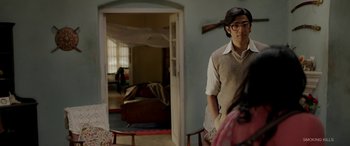 Movie still from “A Death in the Gunj” (2016), directed by Konkona Sen Sharma – A man in a room with a gun in his hand; Medium shot, Over the shoulder angle