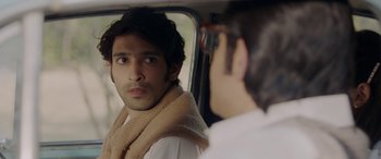 Movie still from “A Death in the Gunj” (2016), directed by Konkona Sen Sharma – A man looking into a mirror while standing in a car; Close Up shot, Over the shoulder angle
