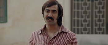 Movie still from “A Death in the Gunj” (2016), directed by Konkona Sen Sharma – A man in a red and white checkered shirt; Close Up shot, Over the shoulder angle