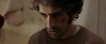 Movie still from “A Death in the Gunj” (2016), directed by Konkona Sen Sharma – A person with blood on his face; Close Up shot, Low angle