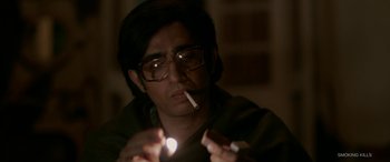 Movie still from “A Death in the Gunj” (2016), directed by Konkona Sen Sharma – A man with glasses is smoking a cigarette; Close Up shot, Low angle