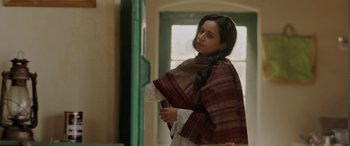 Movie still from “A Death in the Gunj” (2016), directed by Konkona Sen Sharma – A young woman in an indian dress looking at a window; Medium shot, Low angle